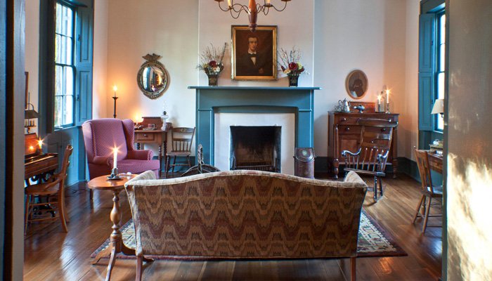Sitting room couch fireplace at 1840 Tucker House Bed and Breakfast in Louisville, Kentucky